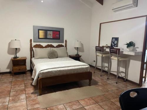 a bedroom with a bed and a table and chairs at Sea view Apartment in Puerto Limón