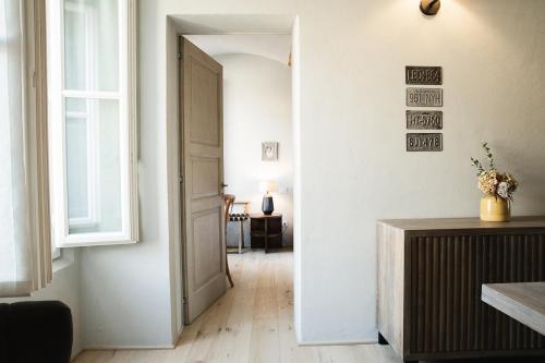 a hallway with a door leading to a living room at Le Antiche Mura in Guastalla