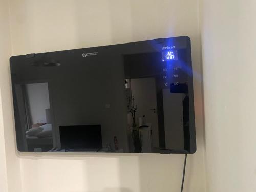 a mirror hanging on a wall in a room at Vivian's cozy apartment in Larisa