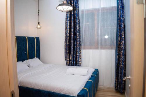 a small bed in a room with a window at Nairobi City view1 BDRM condo with pool and gym in Nairobi
