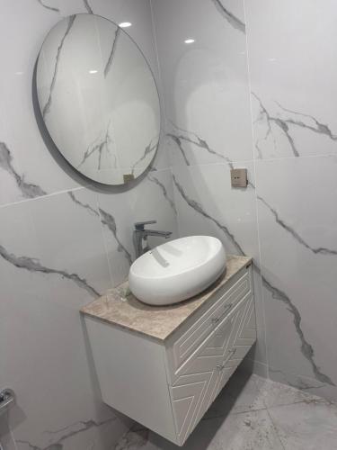 a bathroom with a sink and a mirror on a counter at Rova Hotel in Baku