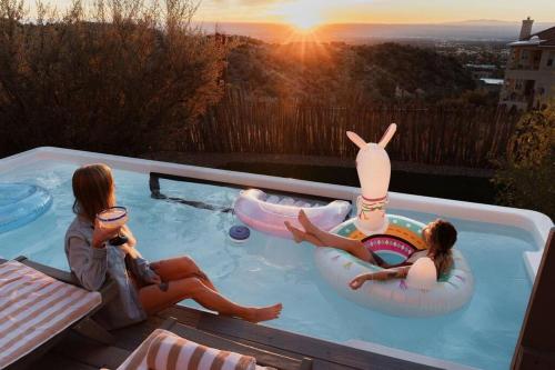 two girls sitting in a pool with inflatable boats at BEST VIEWS in Albuquerque with hot tub and pool in Albuquerque