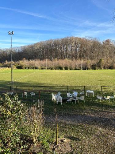 a group of tables and chairs in a field at 't Cravael in Meldert