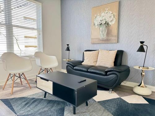a living room with a black leather couch and chairs at Luxury New 1B1B Private Balcony w Dryer Washer 525Pkwy211 in Atlanta