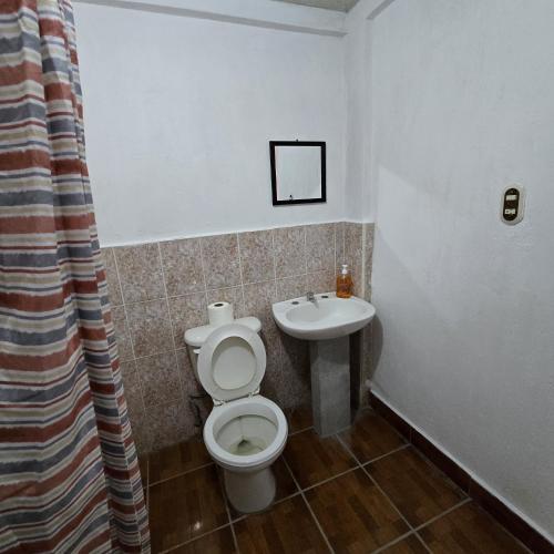 a bathroom with a toilet and a sink at Apartamentos el viajero in Panajachel