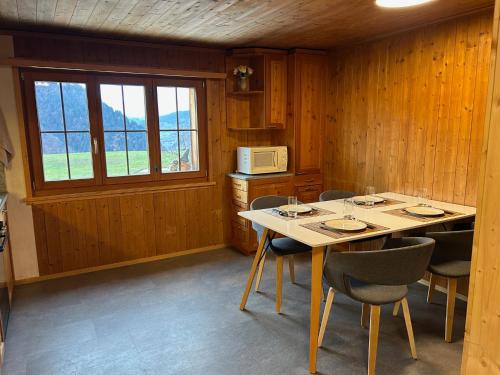 a dining room with a table and chairs and a microwave at Latura - 3.5 Zimmerwohnung für 4 Personen, 80m2 in Buchen