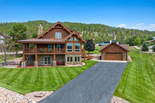 a home with a driveway leading to a house at Reunion Lodge in Sturgis