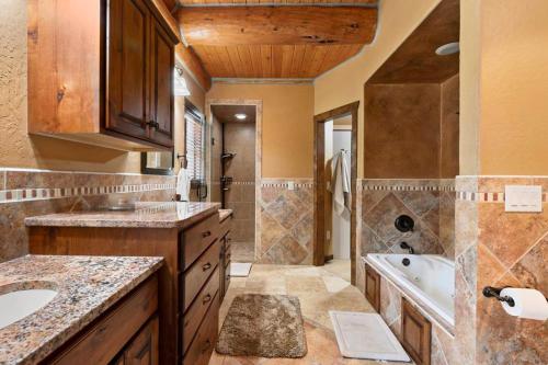 a large bathroom with a sink and a tub at Reunion Lodge in Sturgis