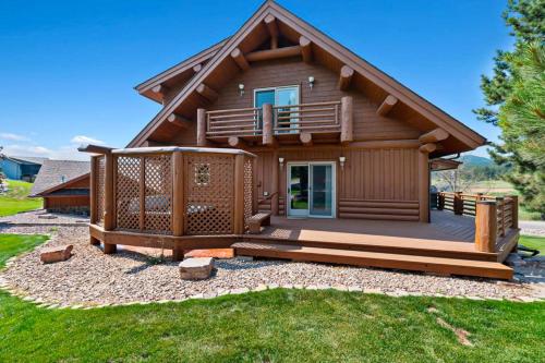 a log cabin with a porch and a deck at Reunion Lodge in Sturgis