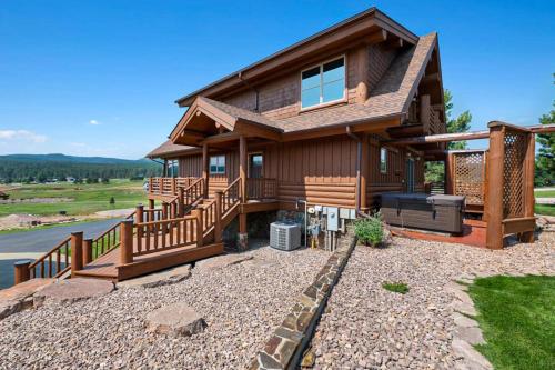 a log home with a large deck and a patio at Reunion Lodge in Sturgis