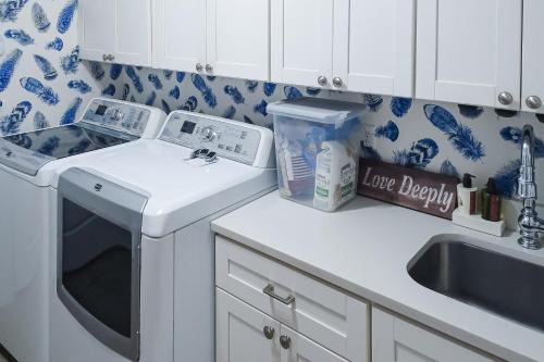 a kitchen with a sink and a dishwasher at The Rookery in Blackbanks