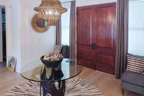 a glass table in a living room with a chandelier at The Rookery in Blackbanks