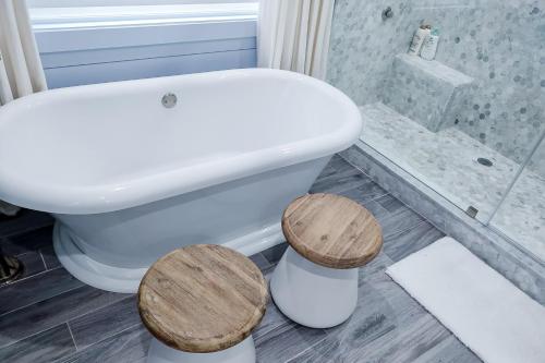 a bathroom with a toilet and two wooden stools at The Rookery in Blackbanks