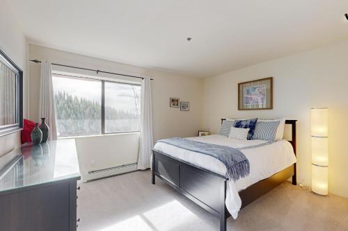 a bedroom with a bed and a large window at Bear-foot Retreat in Incline Village
