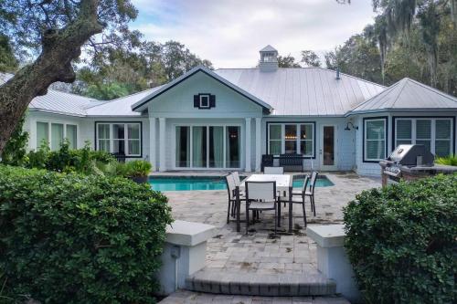 a house with a patio and a swimming pool at The Rookery in Blackbanks