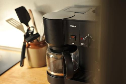 a black coffee maker sitting on top of a counter at The Writer's House in Canterbury