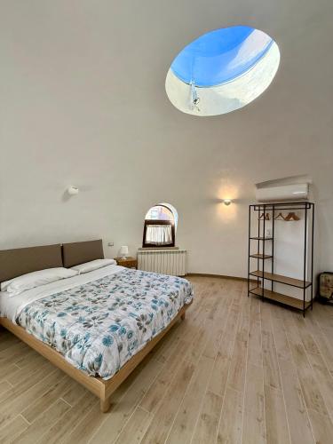 a bedroom with a bed and a large window at Miele B&B in Vinchiaturo