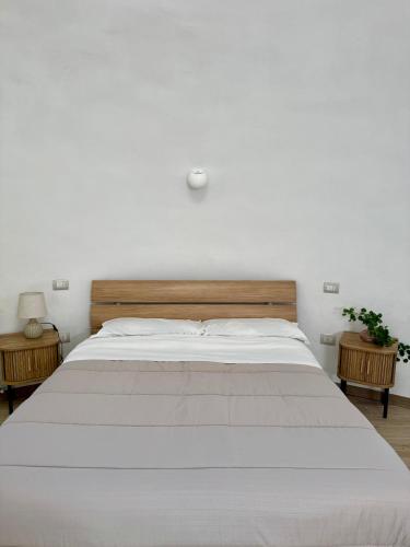 a bedroom with a large white bed and two tables at Miele B&B in Vinchiaturo