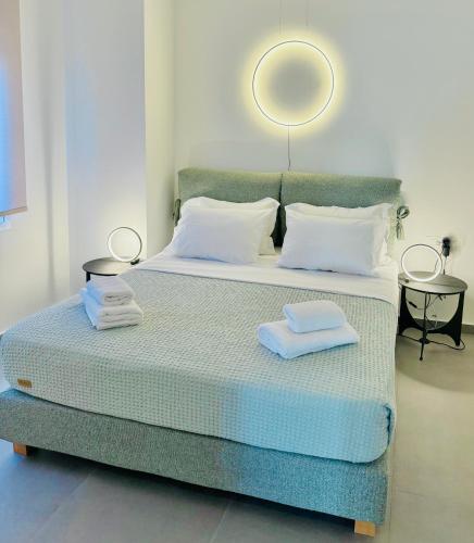 a bedroom with a bed with two towels on it at Centro 247 Luxury apartment in Ierápetra