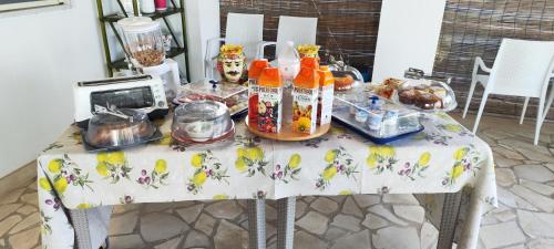 a table with food and drinks on it at Villa Giummarito in Scicli