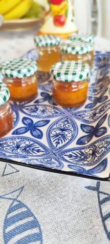 a tray with several jars of honey on a table at Villa Giummarito in Scicli