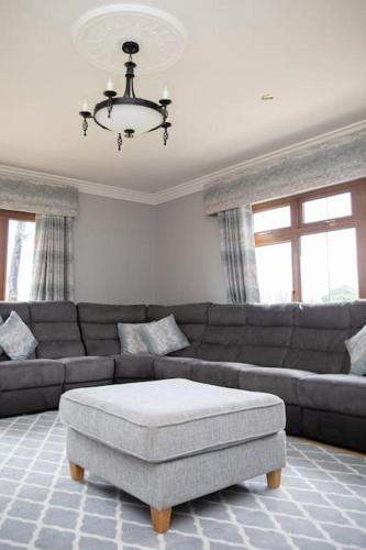 a living room with a couch and a table at Tara Manor - Family gathering's & hen parties in Omagh