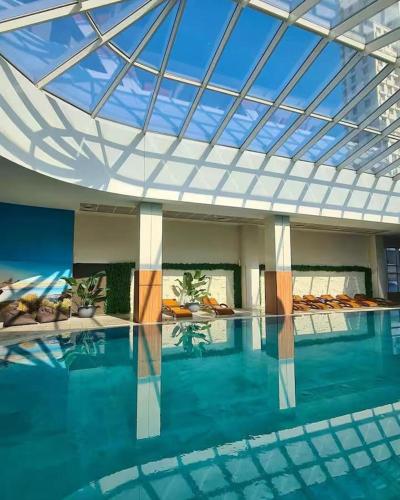 a large swimming pool with a glass ceiling at Sky Lux Point in Skopje