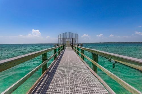 a boardwalk leading to a building in the water at Sunset Harbor Palms 1-308 in Navarre