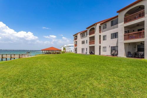 a view of a building with the ocean in the background at Sunset Harbor Palms 1-308 in Navarre