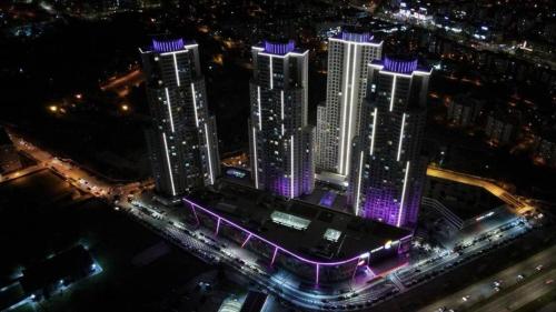 a group of tall buildings in a city at night at Sky Lux Point in Skopje