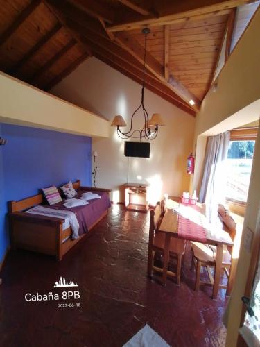 a bedroom with a bed and a table in a room at Don Justo in San Carlos de Bariloche