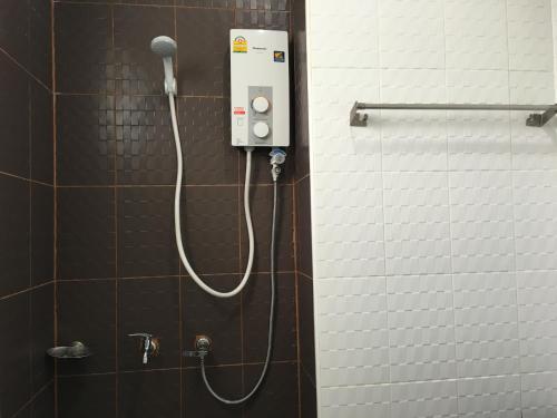 a shower with a blow dryer in a bathroom at Baan Samrarn in Krabi town