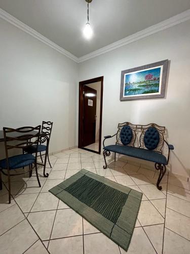 a living room with a couch and a table and chairs at Fênix Plaza Hotel in Aquidauana