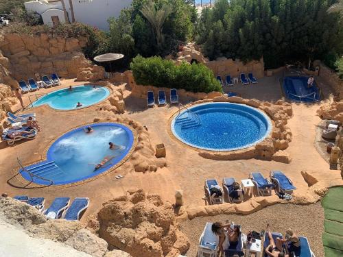 an overhead view of two pools in a resort at Domina Coral Bay Harem in Sharm El Sheikh