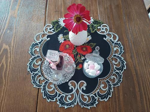 a table with two vases and flowers on a table at Xenonas Drimos in Karpenision