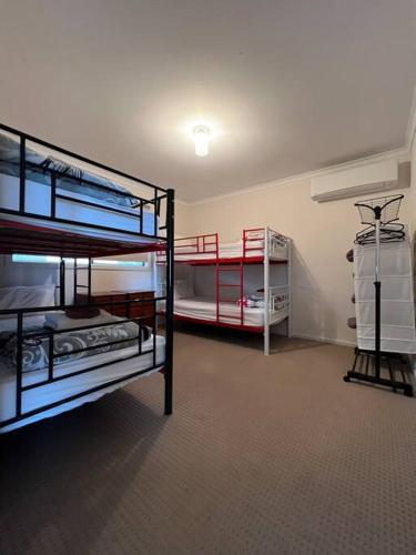 a room with two bunk beds in a room at Sandcastle - A Esplanade Place, Stunning Views in Kingscote