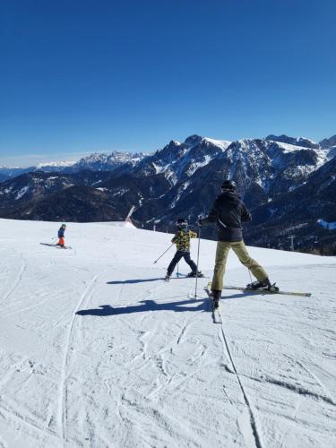 a group of people skiing down a snow covered slope at Krebslechnerhof in Brunico