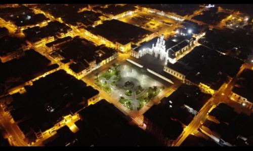 an aerial view of a city at night at Hostal La Suite in Sangolquí