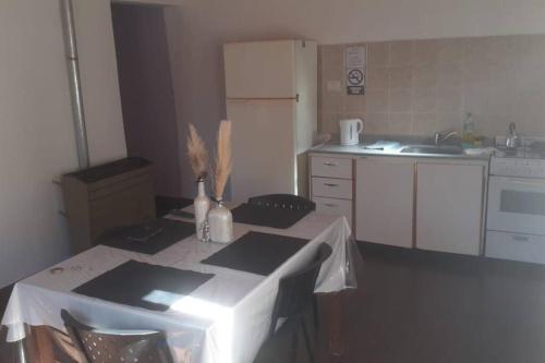 a kitchen with a table with a table cloth on it at departamento por día ruta 41 2 in Los Antiguos