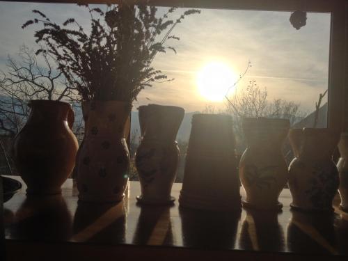 a group of vases sitting on a table in front of the sun at Azienda Agricola Il Querceto in Marsico Vetere