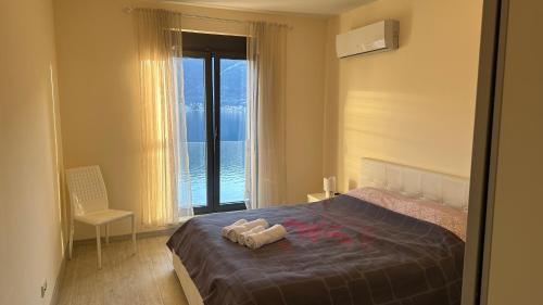 a bedroom with a bed with a view of the ocean at Drazn vrt in Kotor