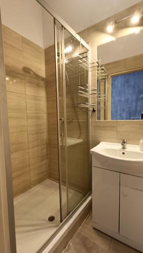 a bathroom with a shower and a sink at Hotel Polonia in Namysłów