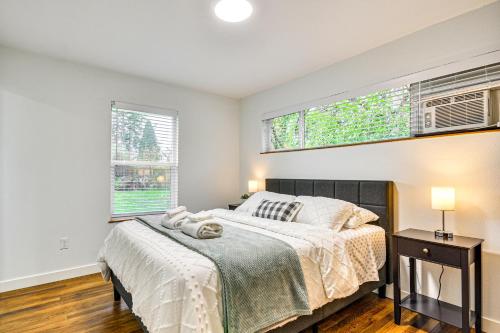 a bedroom with a bed and two windows at Modern Home with Spacious Yard in Beaverton! in Beaverton