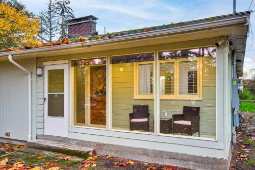 a screened in porch of a house with two chairs at Modern Home with Spacious Yard in Beaverton! in Beaverton
