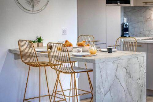a kitchen with a marble counter and chairs at #HE The Golden Escape Ile Verte luminous renovated in Grenoble