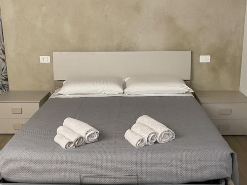 a bed with two rolled up towels on it at Agriturismo San Pellegrino in Fermignano