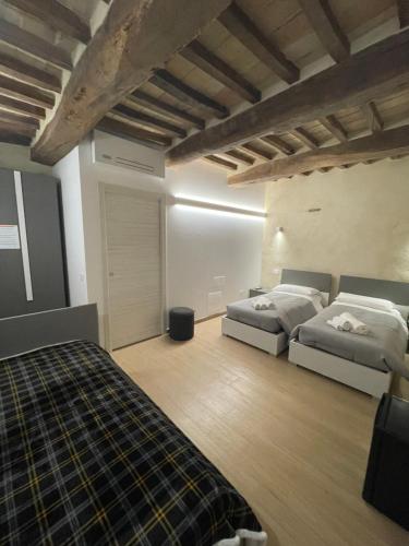a bedroom with two beds in a room at Agriturismo San Pellegrino in Fermignano