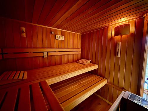 a small wooden sauna with a bench in it at Słoneczny Stok in Małastów