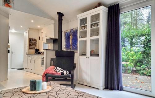 a living room with a chair and a large window at Stunning Home In Vorden With Wifi in Vorden