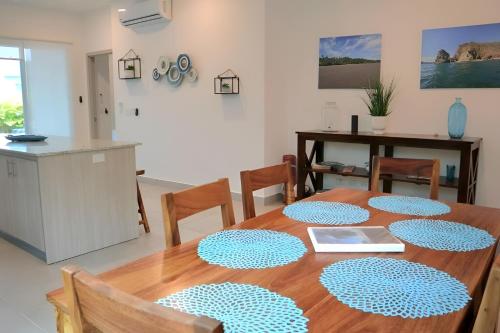 a dining room with a wooden table and chairs at Tranquil Tides Costa Rica in Pochote